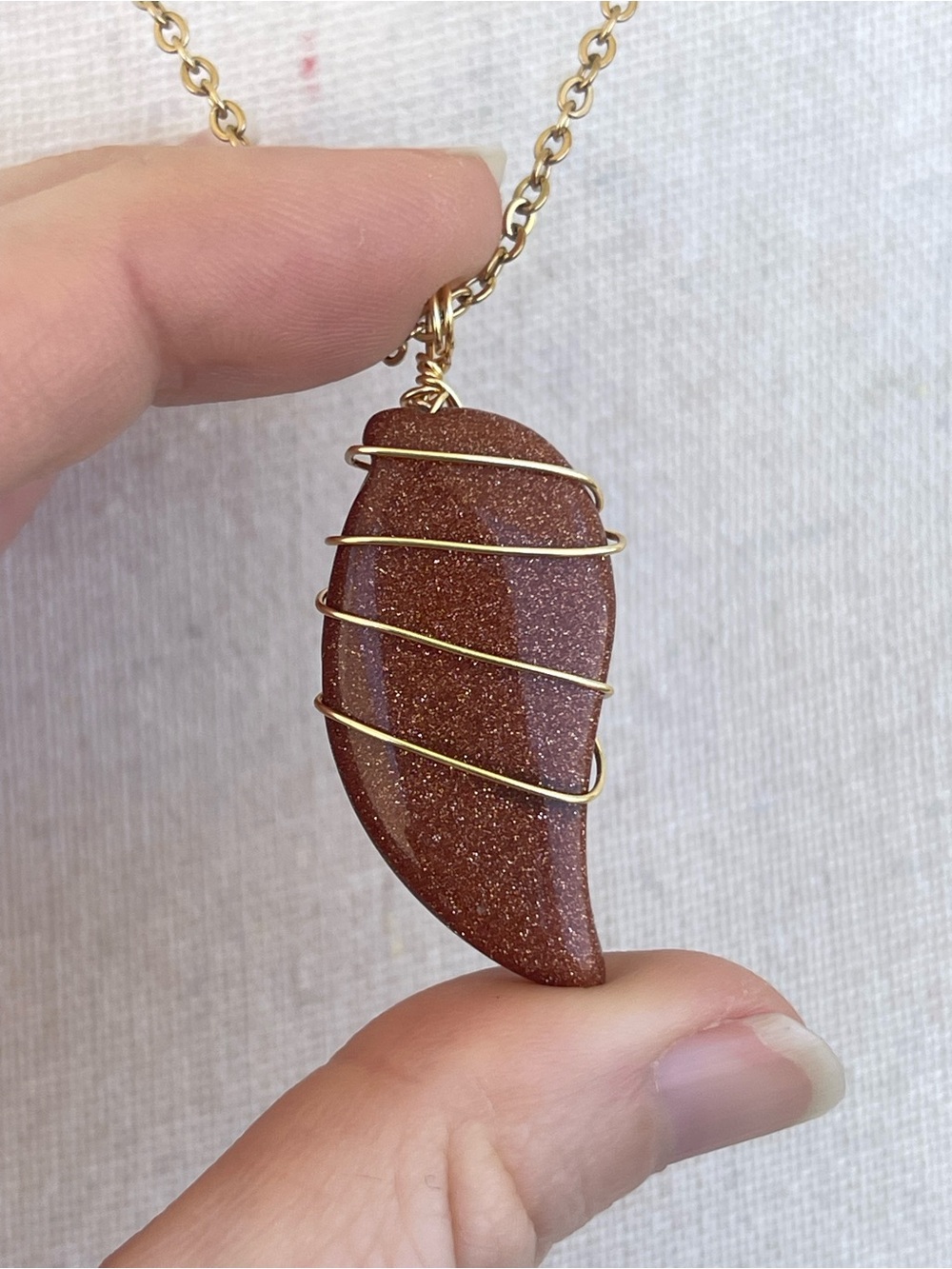 Goldstone Pendant Necklace with Gold Wire Wrap